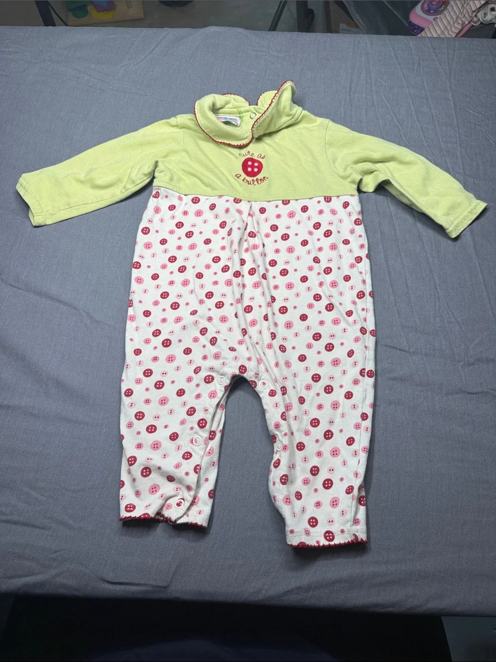 Vintage small steps Green Baby Onesie with Red Trim and Button Motif